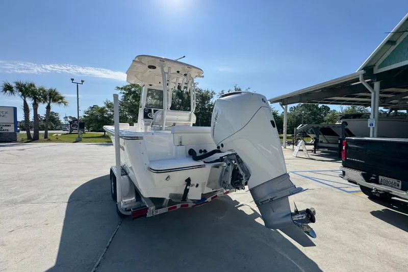 Slide: The Image of 2027 Sea Born LX22 Center Console boat on trailer in sunny outdoor setting. - 13