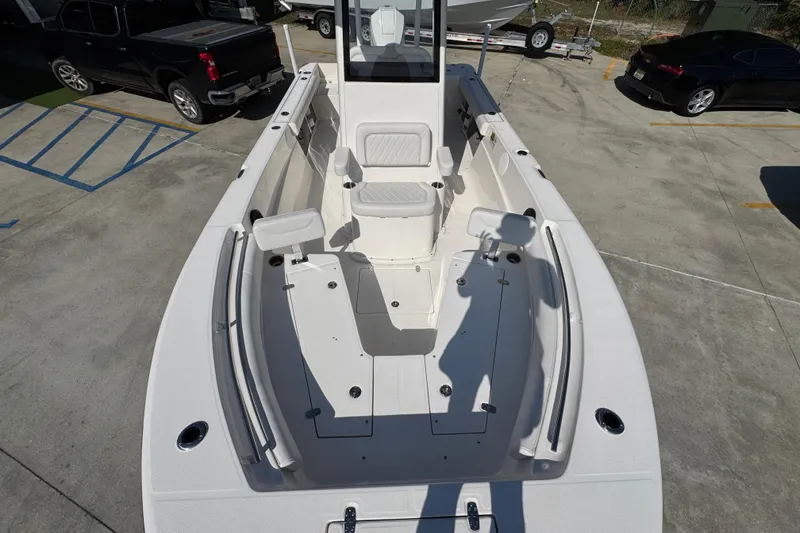 Slide: The Image of 2027 Sea Born LX22 Center Console boat, spacious deck view in a parking lot. - 19