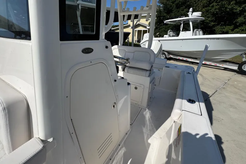 Slide: The Image of 2027 Sea Born LX22 Center Console boat interior with seating and steering wheel. - 22
