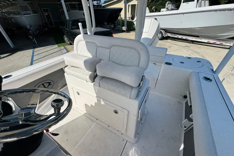 Slide: The Image of 2027 Sea Born LX22 Center Console boat interior with white seating and steering wheel. - 24