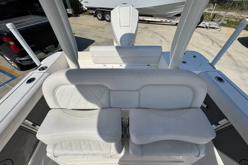 Slide: The Image of 2027 Sea Born LX22 Center Console boat interior with white cushioned seating. - 25