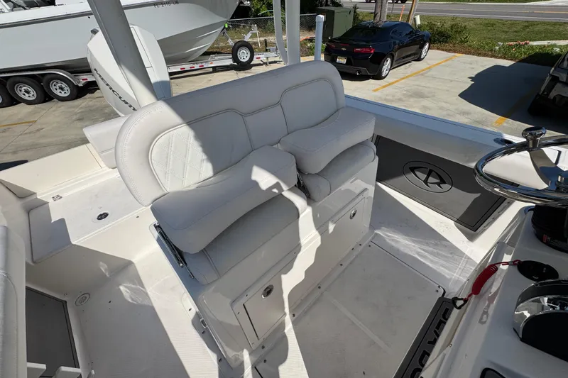 Slide: The Image of 2027 Sea Born LX22 Center Console boat interior with white seating and steering wheel. - 27