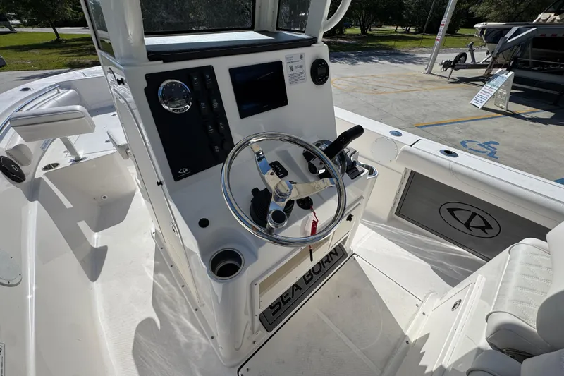 Slide: The Image of 2027 Sea Born LX22 Center Console boat interior with steering wheel and control panel. - 28