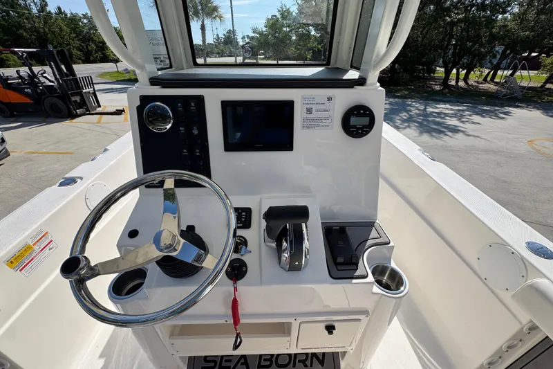 Slide: The Image of 2027 Sea Born LX22 Center Console boat dashboard with steering wheel and controls. - 29