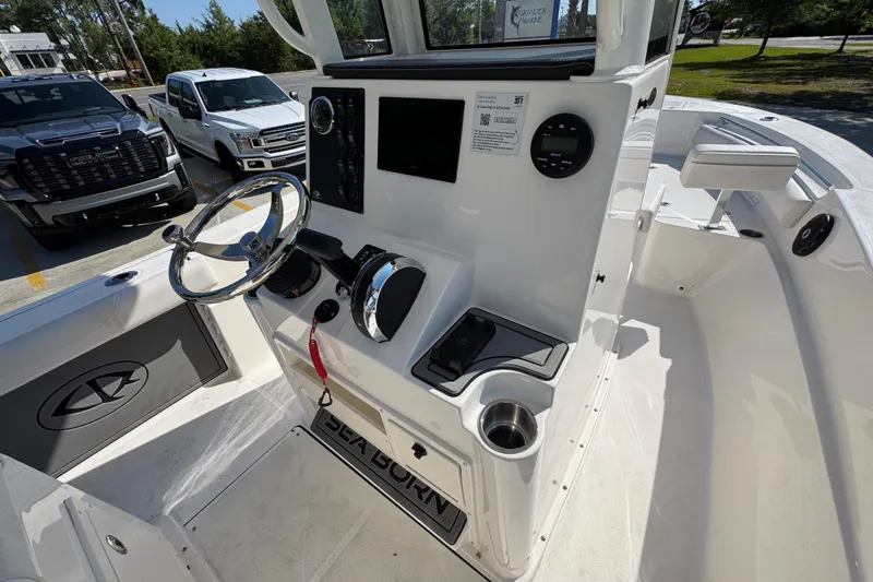 Slide: The Image of 2027 Sea Born LX22 Center Console boat interior with steering wheel and control panel. - 30