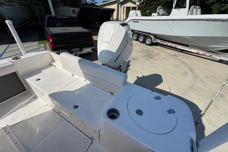 Slide: The Image of 2027 Sea Born LX22 Center Console boat with Mercury engine in a marina setting. - 33