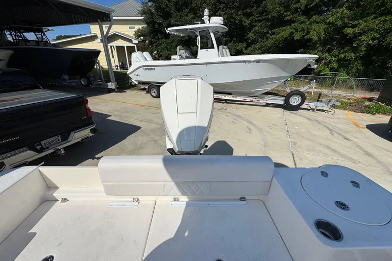 Slide: The Image of 2027 Sea Born LX22 Center Console boat in a parking area with other boats. - 34
