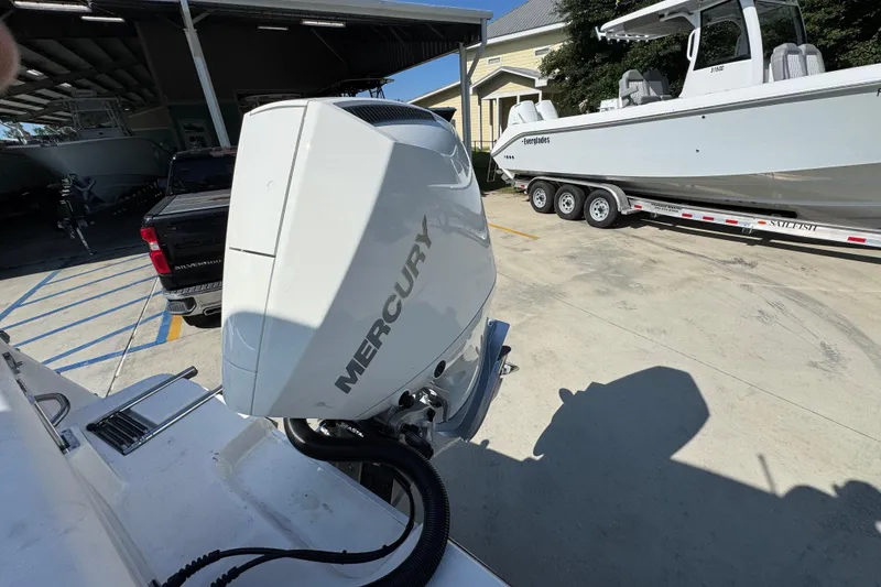 Slide: The Image of 2027 Sea Born LX22 Center Console with Mercury outboard engine in a marina setting. - 37
