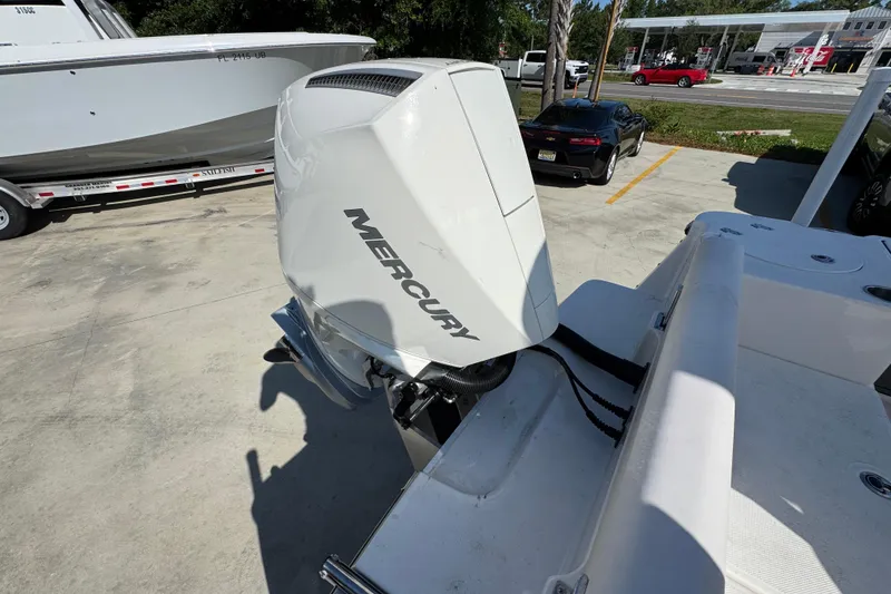 Slide: The Image of 2027 Sea Born LX22 Center Console with Mercury outboard engine in a parking lot. - 38