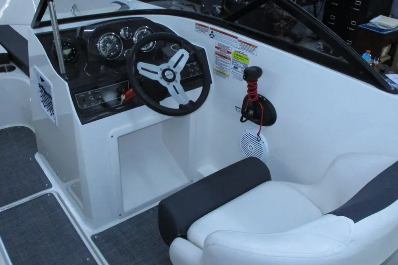 Slide: The Image of 2020 Bayliner VR4 Bowrider OB cockpit with steering wheel and controls. - 12