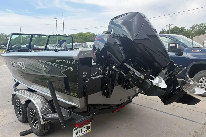 Slide: The Image of 2023 Lund 1975 Tyee boat on trailer with powerful outboard motor. - 2