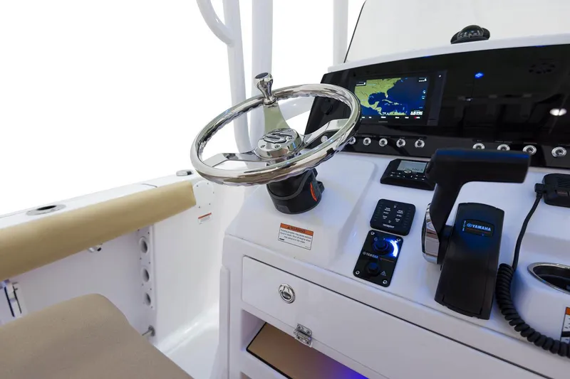 Slide: The Image of Manufacturer Provided Image: 2021 Sportsman Open 232 Center Console boat helm with steering wheel and navigation system. - 10