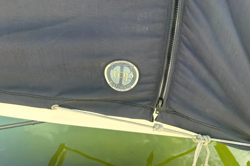 Slide: The Image of Boat cover with "Top" logo on a 2021 Sportsman Open 232 Center Console. - 27