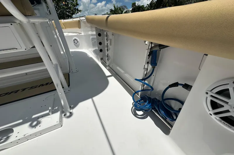 Slide: The Image of 2021 Sportsman Open 232 Center Console interior with seating, speaker, and coiled blue hose. - 29