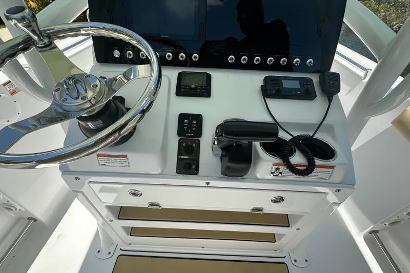 Slide: The Image of Center console of 2021 Sportsman Open 232 boat with steering wheel and controls. - 33