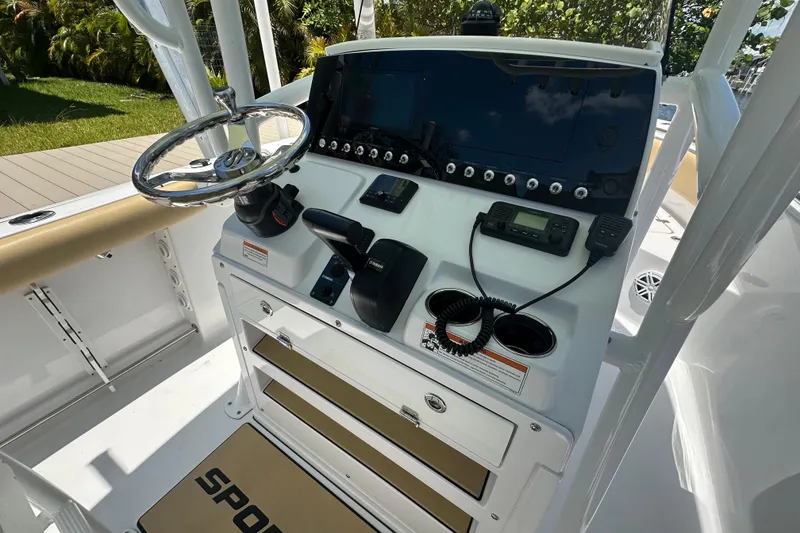 Slide: The Image of 2021 Sportsman Open 232 Center Console boat dashboard with steering wheel and controls. - 34