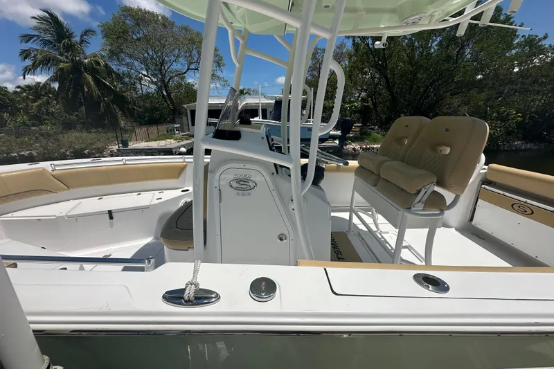 Slide: The Image of 2021 Sportsman Open 232 Center Console boat with beige seating and sleek design. - 35