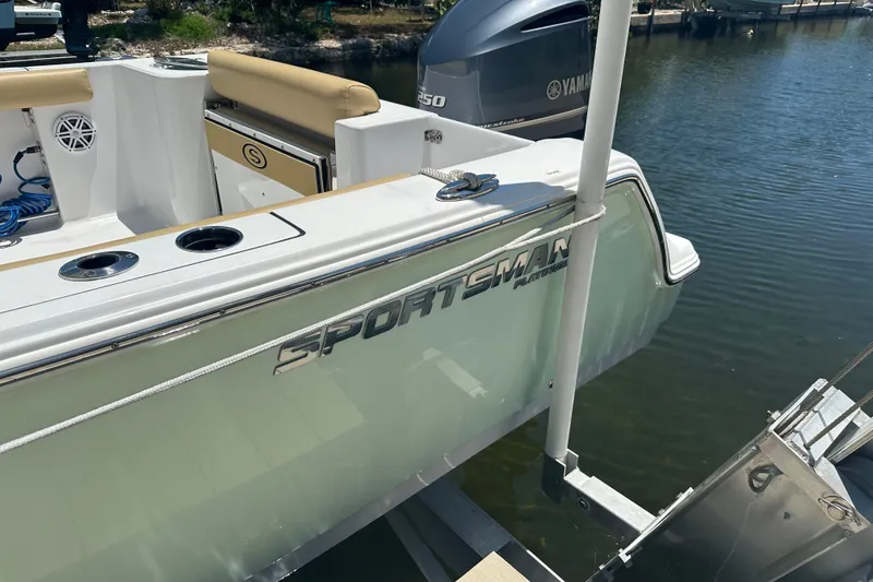 Slide: The Image of 2021 Sportsman Open 232 Center Console boat docked by the water. - 39