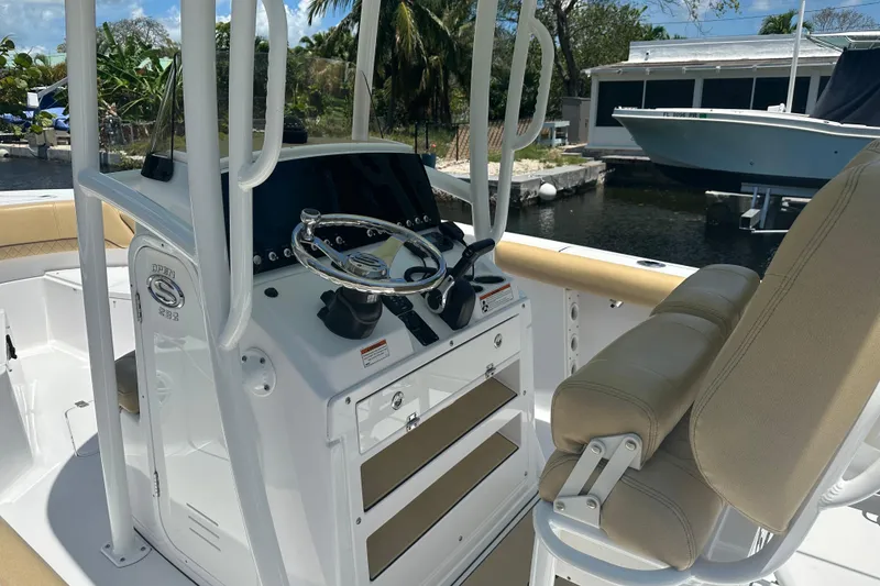 Slide: The Image of 2021 Sportsman Open 232 Center Console boat interior with steering wheel and seating. - 41