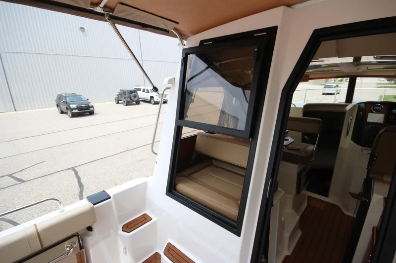 Slide: The Image of Interior view of 2025 Ranger Tugs R-25 boat with seating and dashboard. - 11
