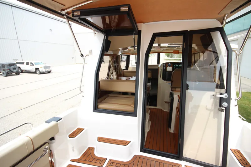 Slide: The Image of 2025 Ranger Tugs R-25 boat interior with teak flooring and modern design. - 12