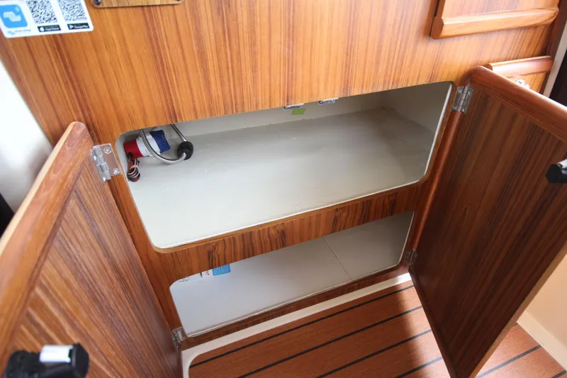 Slide: The Image of Open wooden cabinet in 2025 Ranger Tugs R-25 boat interior. - 22