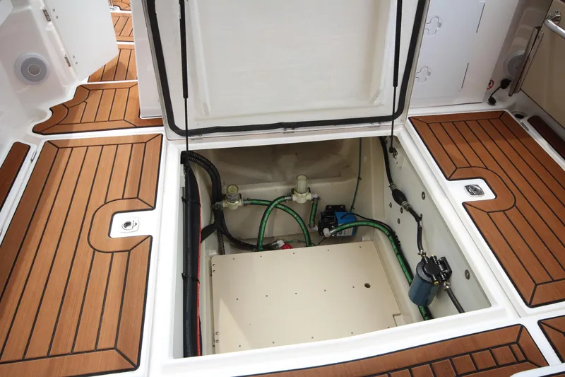 Slide: The Image of 2025 Ranger Tugs R-25 boat interior with open hatch, showcasing engine compartment. - 33