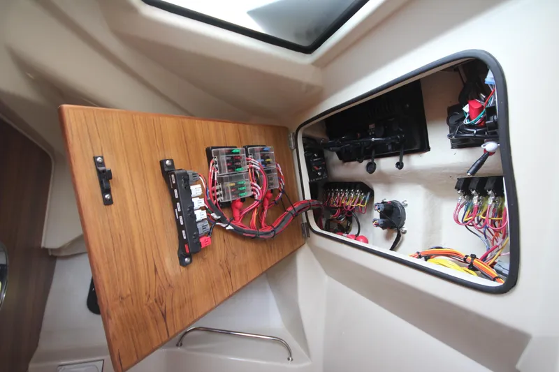 Slide: The Image of Electrical panel inside 2025 Ranger Tugs R-25 boat, showcasing wiring and components. - 36