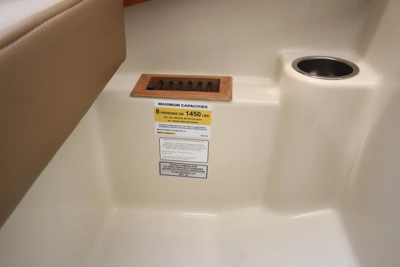 Slide: The Image of Interior of 2025 Ranger Tugs R-25 showing maximum capacity label and cup holder. - 66