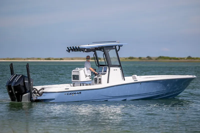 Slide: The Image of 2026 Caymas 281 HB boat cruising on calm waters, featuring sleek design and powerful engines. - 10