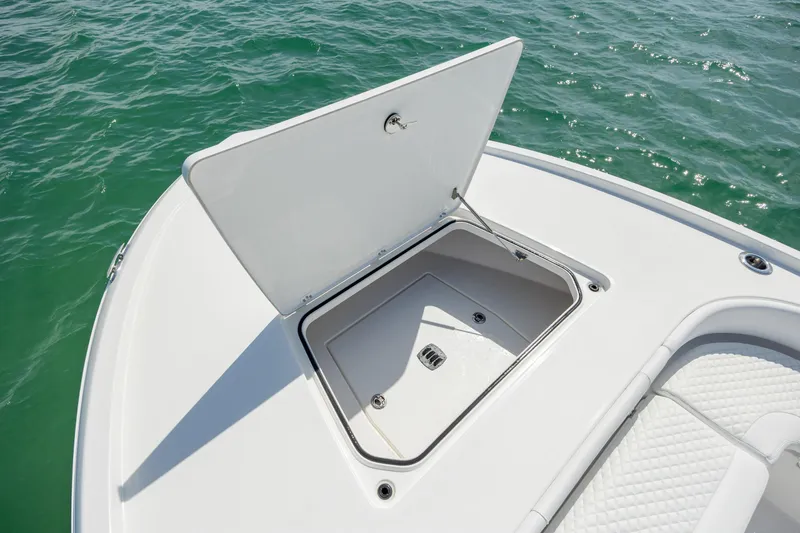 Slide: The Image of Open storage compartment on 2026 Caymas 281 HB boat, floating on clear water. - 13