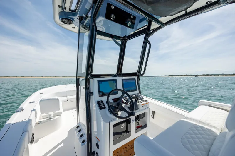 Slide: The Image of 2026 Caymas 281 HB boat interior with modern dashboard on open water. - 19