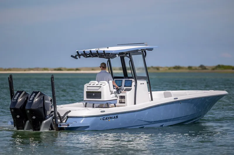 Slide: The Image of 2026 Caymas 281 HB boat cruising on water with dual Mercury engines. - 2