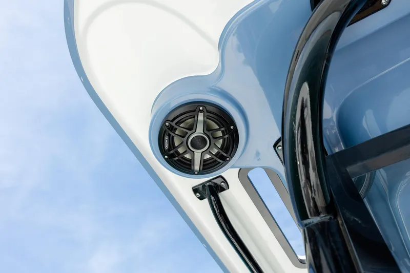 Slide: The Image of 2026 Caymas 281 HB boat speaker and railing against blue sky. - 22
