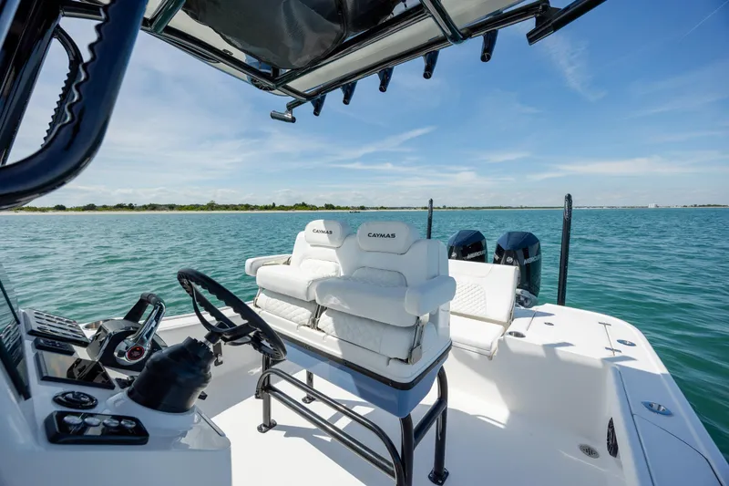 Slide: The Image of 2026 Caymas 281 HB boat interior with dual engines on a sunny day at sea. - 25