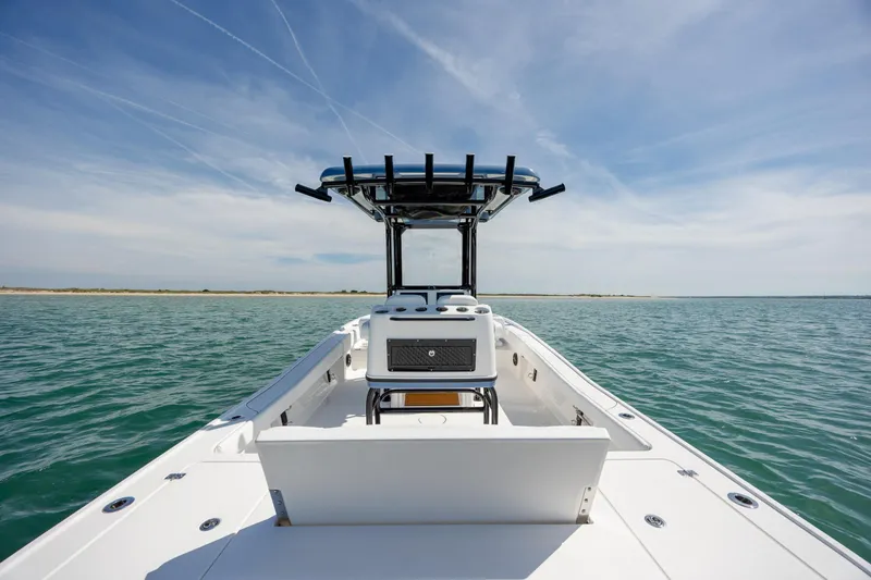 Slide: The Image of 2026 Caymas 281 HB boat on open water under clear blue sky. - 27