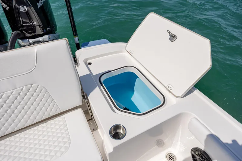 Slide: The Image of 2026 Caymas 281 HB boat interior with open storage compartment and cushioned seating. - 30