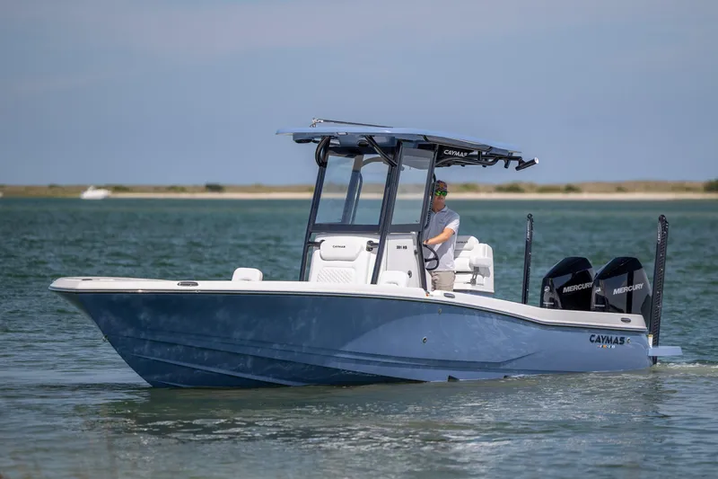 Slide: The Image of 2026 Caymas 281 HB boat cruising on calm waters with dual Mercury engines. - 6