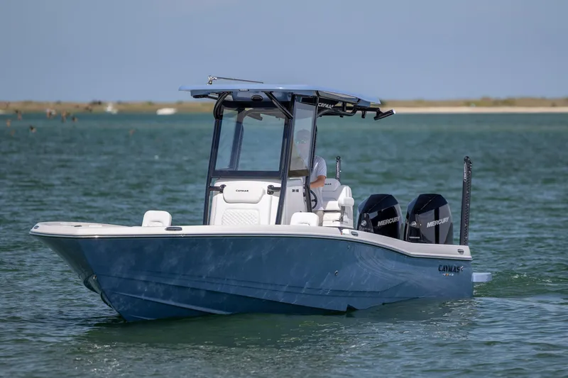 Slide: The Image of 2026 Caymas 281 HB boat cruising on open water with dual Mercury engines. - 7