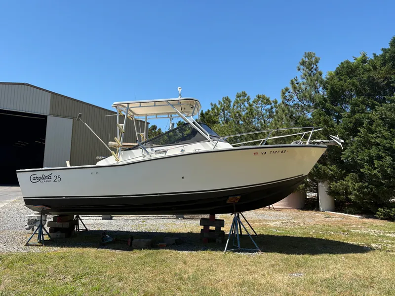 The Image of 1996 Carolina Classic 25 Express boat elevated outdoors. - 0