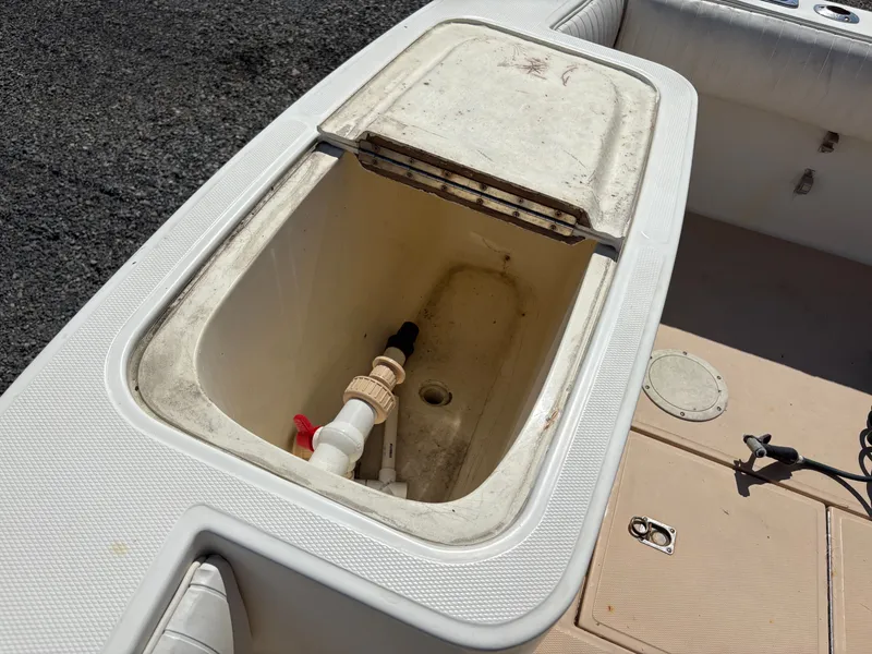Slide: The Image of Open storage compartment on a 1996 Carolina Classic 25 Express boat. - 10