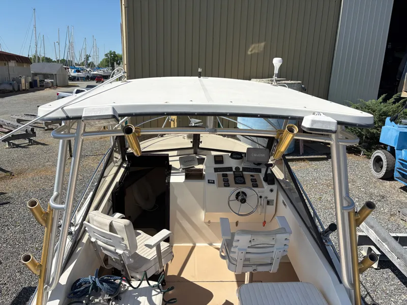Slide: The Image of 1996 Carolina Classic 25 Express boat cockpit view at the marina. - 14