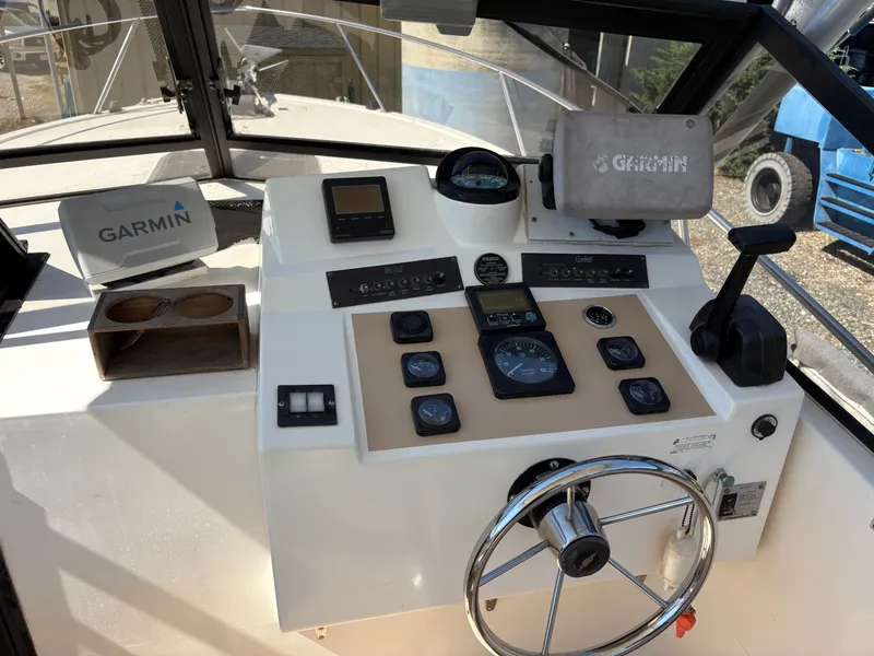 Slide: The Image of 1996 Carolina Classic 25 Express boat dashboard with Garmin equipment. - 15
