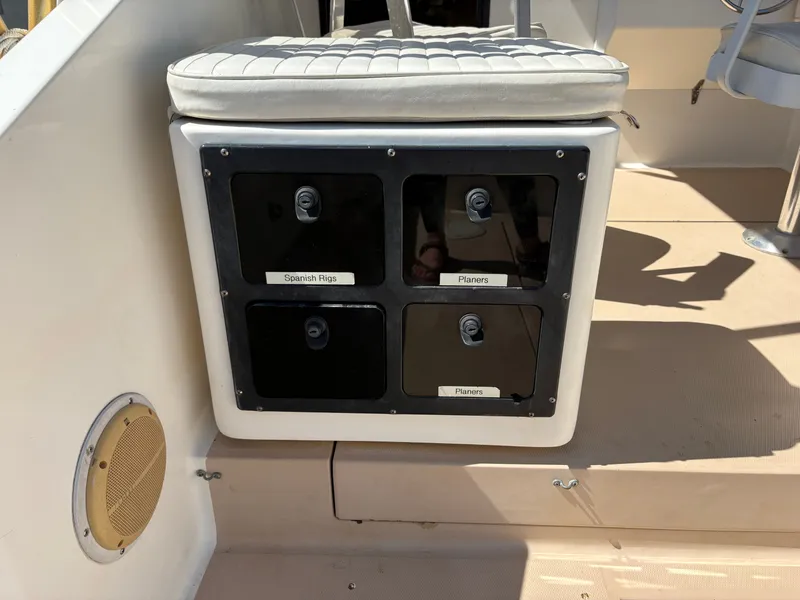 Slide: The Image of 1996 Carolina Classic 25 Express boat with fishing gear compartments. - 19