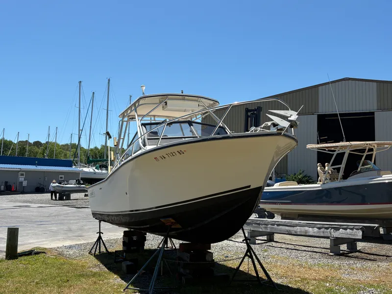 Slide: The Image of 1996 Carolina Classic 25 Express boat on a dry dock. - 2