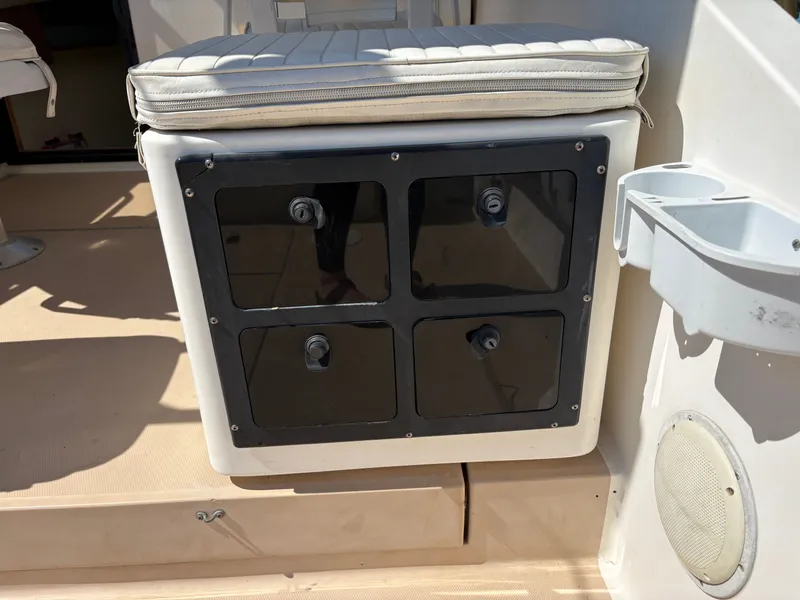 Slide: The Image of 1996 Carolina Classic 25 Express boat seat with storage. - 20