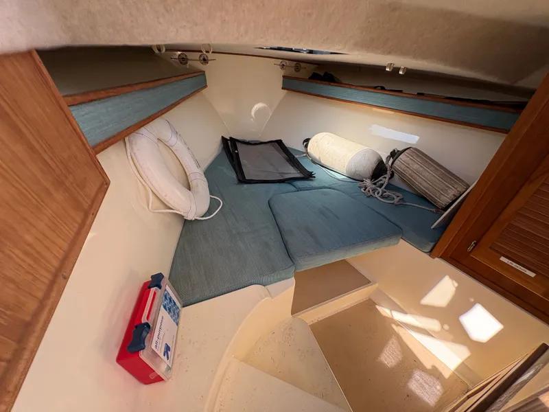 Slide: The Image of Interior of 1996 Carolina Classic 25 Express with blue cushions. - 23