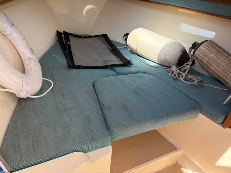 Slide: The Image of Interior of a 1996 Carolina Classic 25 Express boat with blue cushions. - 24