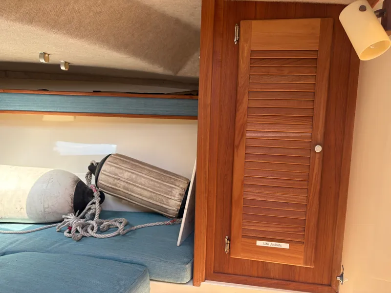 Slide: The Image of Interior of a 1996 Carolina Classic 25 Express boat with wooden cabinet. - 25