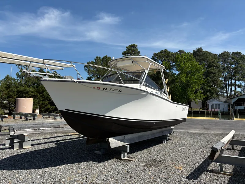 Slide: The Image of 1996 Carolina Classic 25 Express boat on a dry dock. - 3